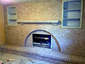 A brick fireplace with glazes applied.